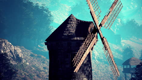 ancient windmill in a misty mountain valley