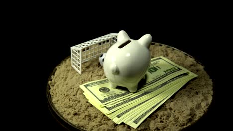 a white piggy bank and dollar bills spins on a black background.