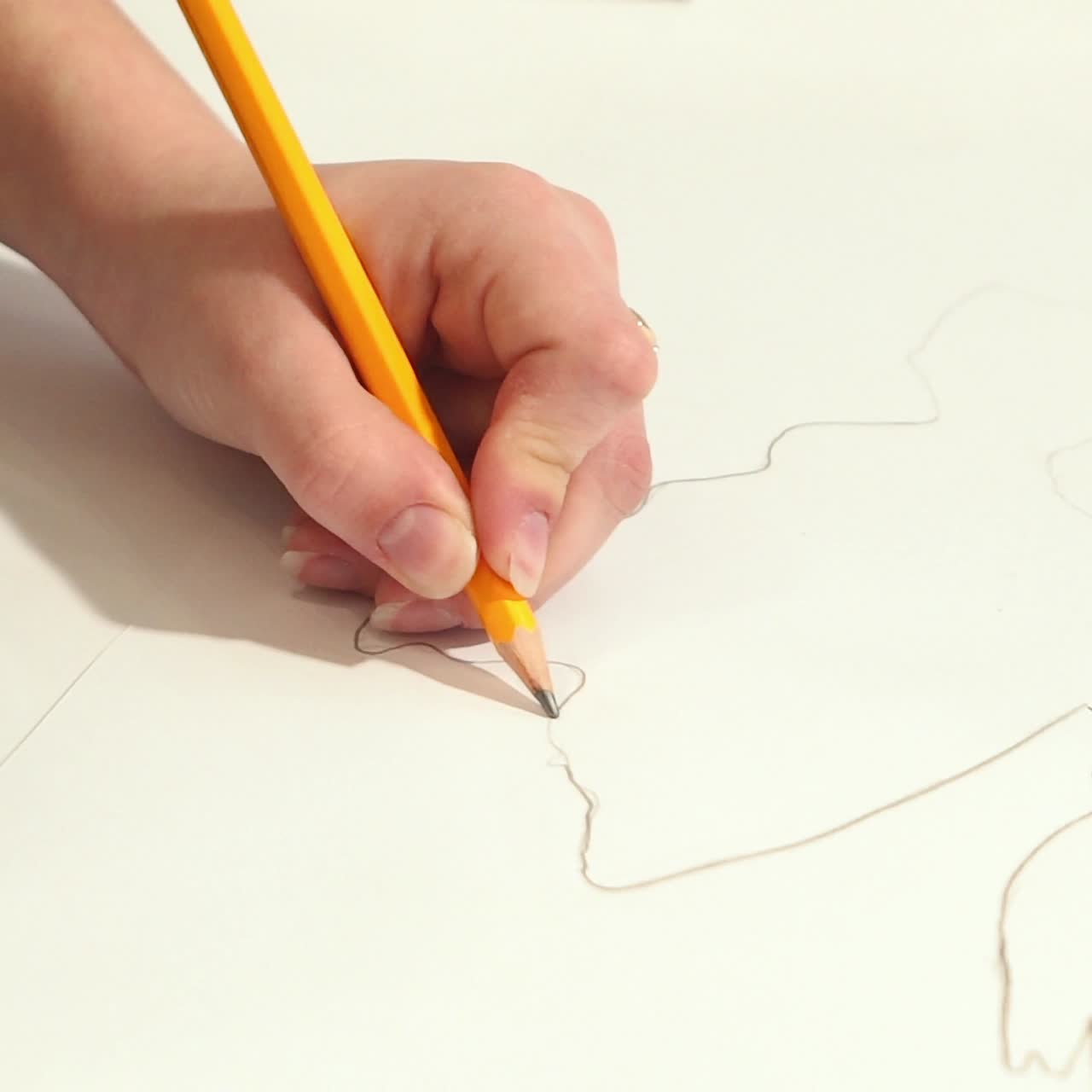 Female hands with a graphite pencil. Young woman learns to draw.
