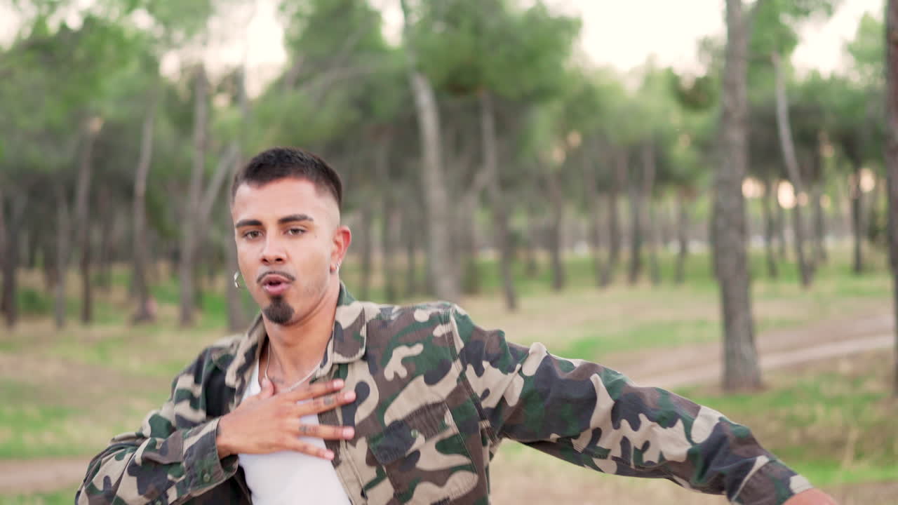 A man dancing outdoors in a forest park