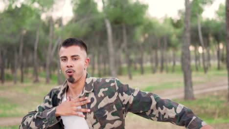 a man dancing outdoors in a forest park
