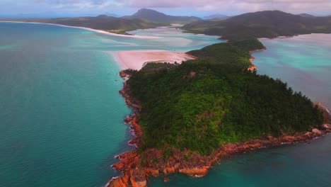 aerial view of a tropical island with turquoise water and white sand beach