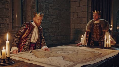 medieval kings consulting a map in a castle