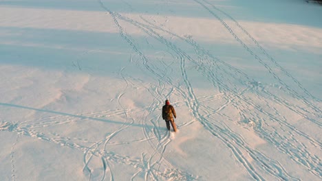 aerial view of ice skating endurance training on frozen lake during golden hour