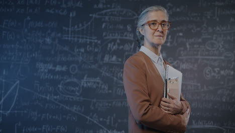 professor in front of a chalkboard filled with equations