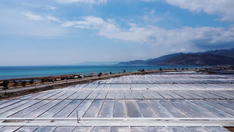 salt-field-crystal-rock-extraction-near-the-ocean-in-Phan-rang-Vietnam-Asia,-Aerial-coastline-farm-view