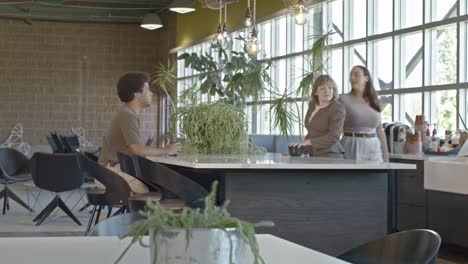 office setting wide shot with one senior citizen woman and four younger workers with dolly video right to left