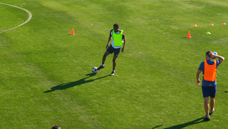 players practicing soccer in the field 4k