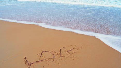 text love on the sea beach and splashing waves on the sand with the slow motion wave in nature concept