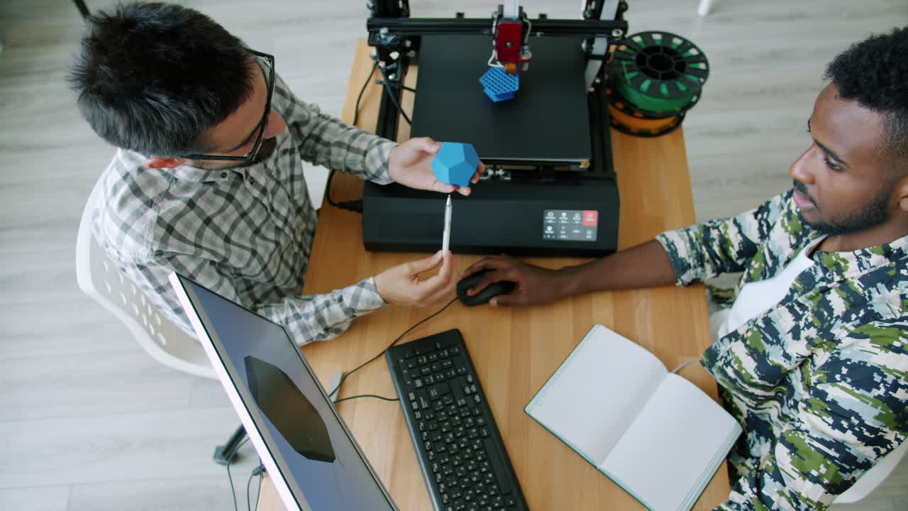 Two people collaborating on a 3D printing project.