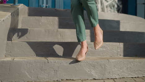 piernas femeninas con zapatos de tacón alto caminan por las escaleras