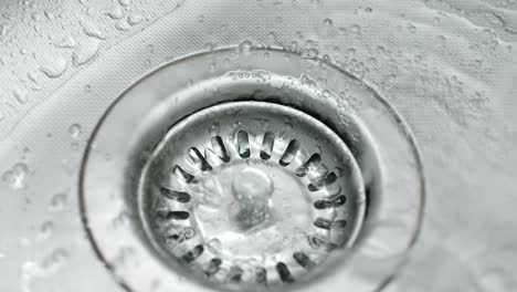 pure fresh water dropping into new shiny sink, motion forward view