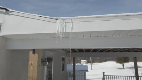 icicles hanging off a roof of a house