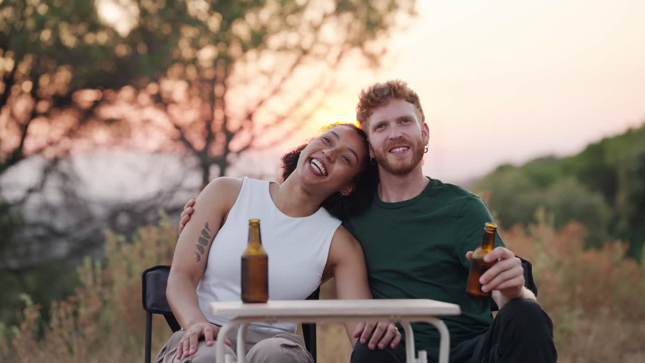 Couple Enjoying Beer Outdoors at Sunset