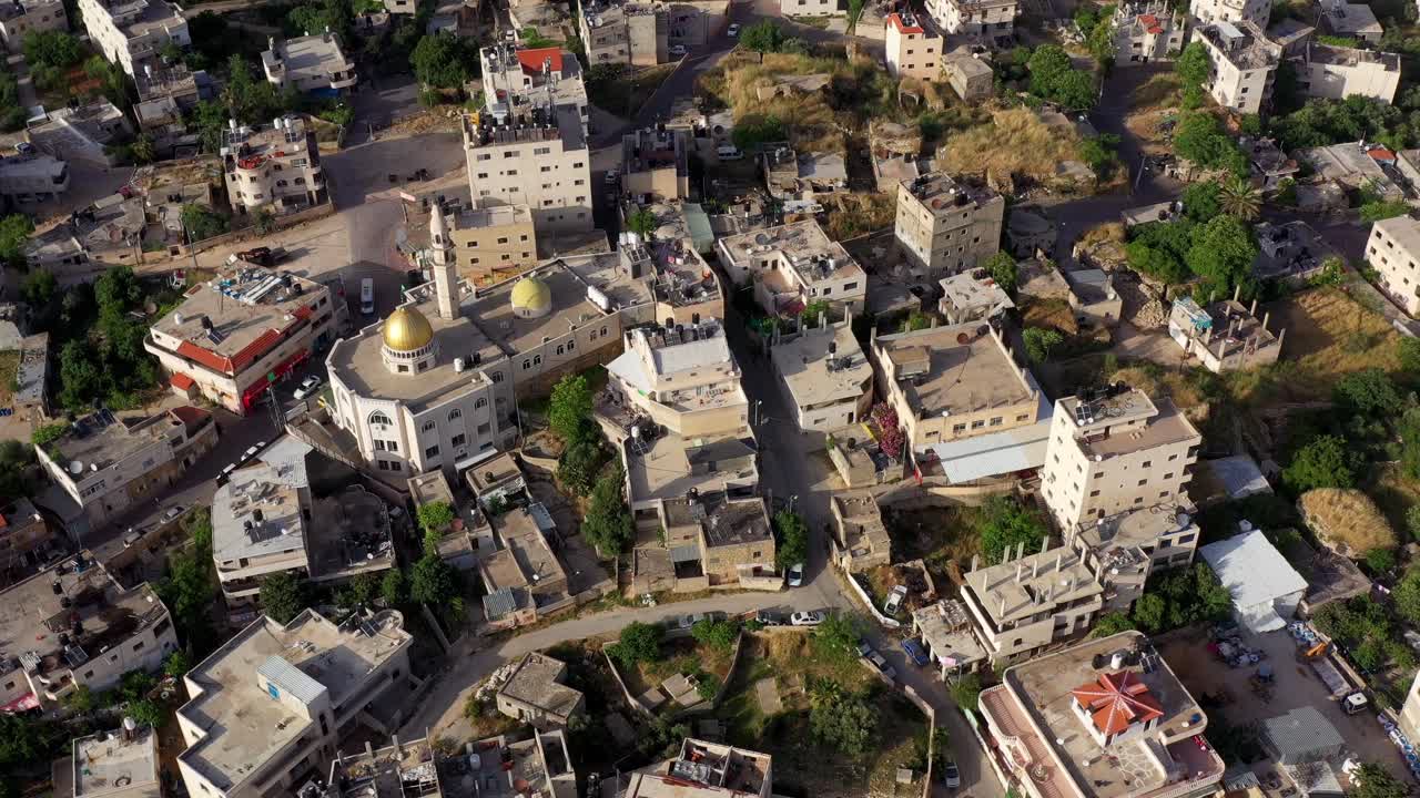 Aerial view of a Middle Eastern town with a prominent mosque