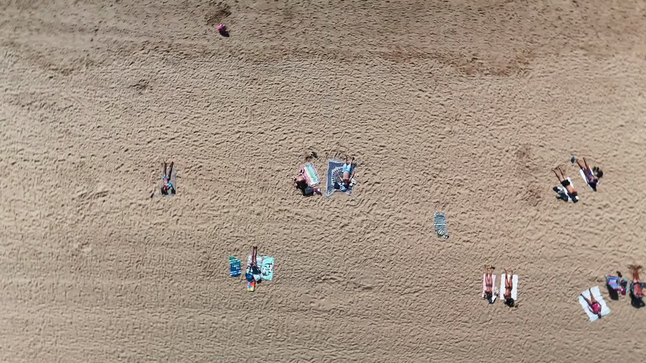 Aerial View of People Relaxing on a Sandy Beach
