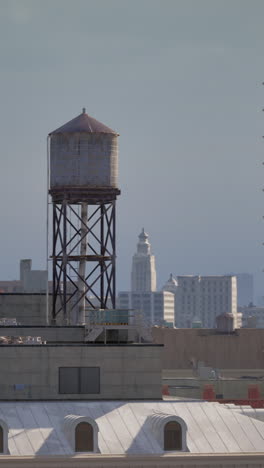 a water tower on a rooftop in the city