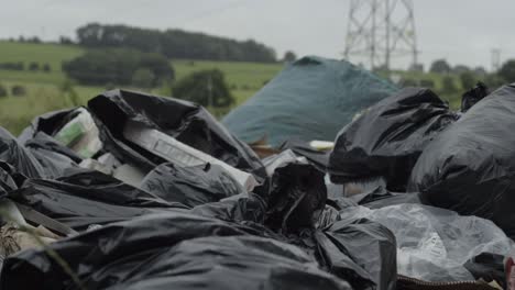 Illegal-waste-and-garbage-dumped-in-countryside-close-up-panning-shot