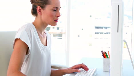 Businesswoman-working-at-her-desk