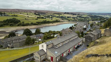 Aerial-video-of-an-industrial-rural-village-with-old-mill-and-chimney-stack-surrounded-by-fields