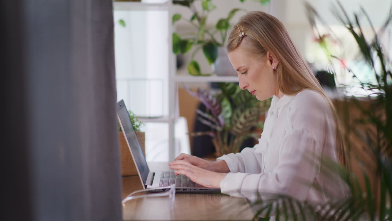 Joyful Woman Writing on Laptop