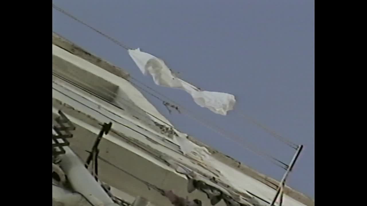 Looking up at residential building with hanging laundry