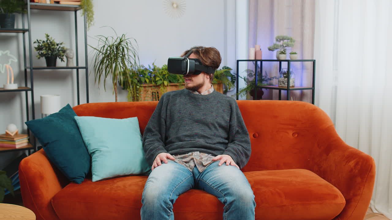 Bearded man use virtual reality futuristic technology headset play simulation 3d video game at home