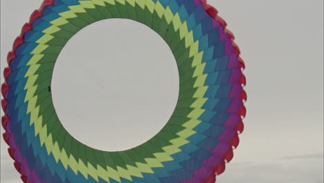 Big-spinning-kite-flying-in-the-sky-at-a-kite-festival-in-Wakefield-UK