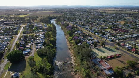 tennis academy and houses on the banks of richmond river in casino town, new south wales, australia