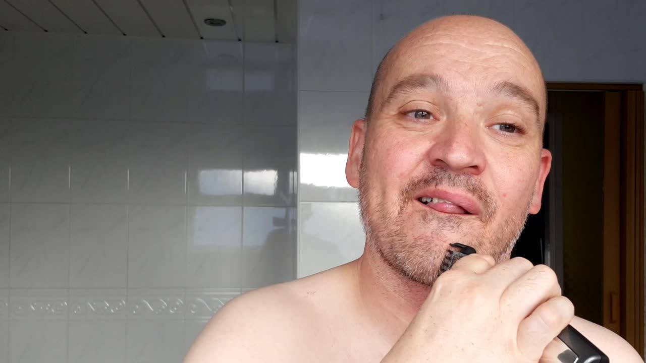 Male shaves with an electric razor