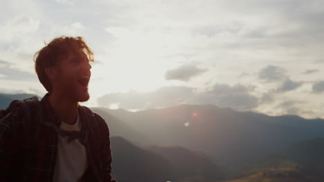 happy traveler hike mountains closeup. young tourist reach peak on nature sunset