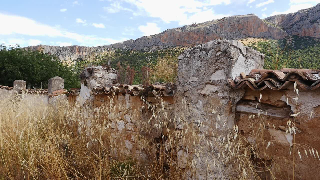 Old and ruined wall of the cemetery of Otiñar, Santa Cristina with clay tiles