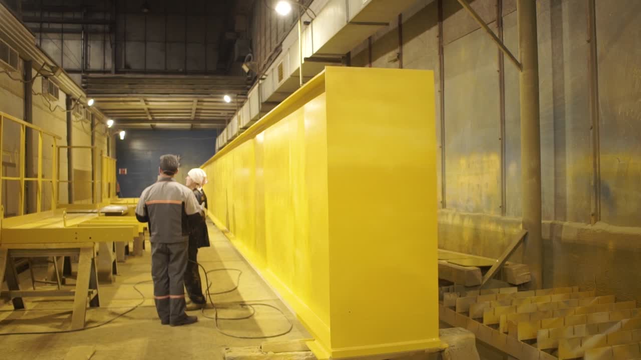 Painting Large Metal Beams in Industrial Facility
