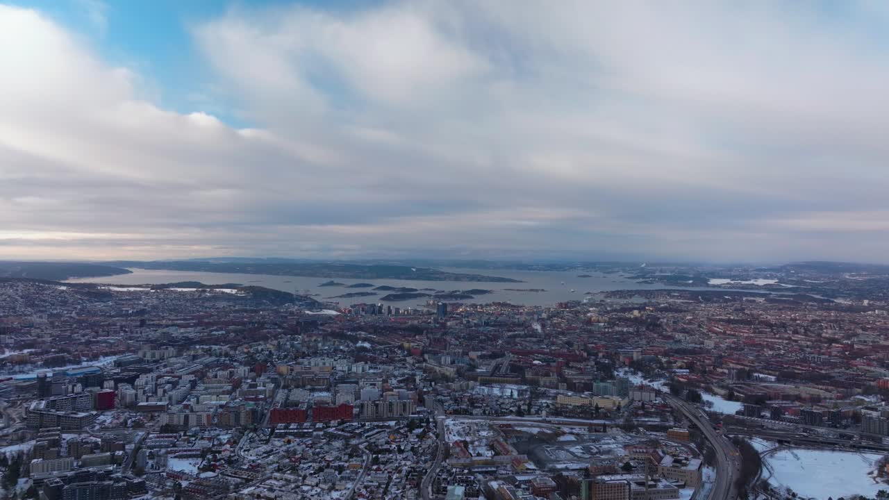 Winter cityscape landscape Oslo Norway Norge downtown OsloFjord water Fjord arctic circle Scandinavia Gamle Hovedoya early morning snowy sunny blue skies clouds tall buildings neighborhood forward pan