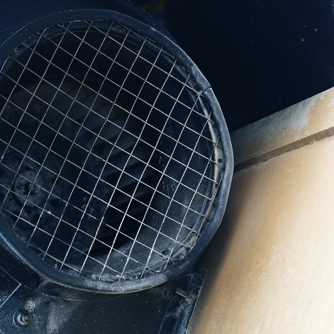 Big diameter tube covered with net and twirling core inside. Industrial equipment outdoors in the exterior of modern plant. Close up