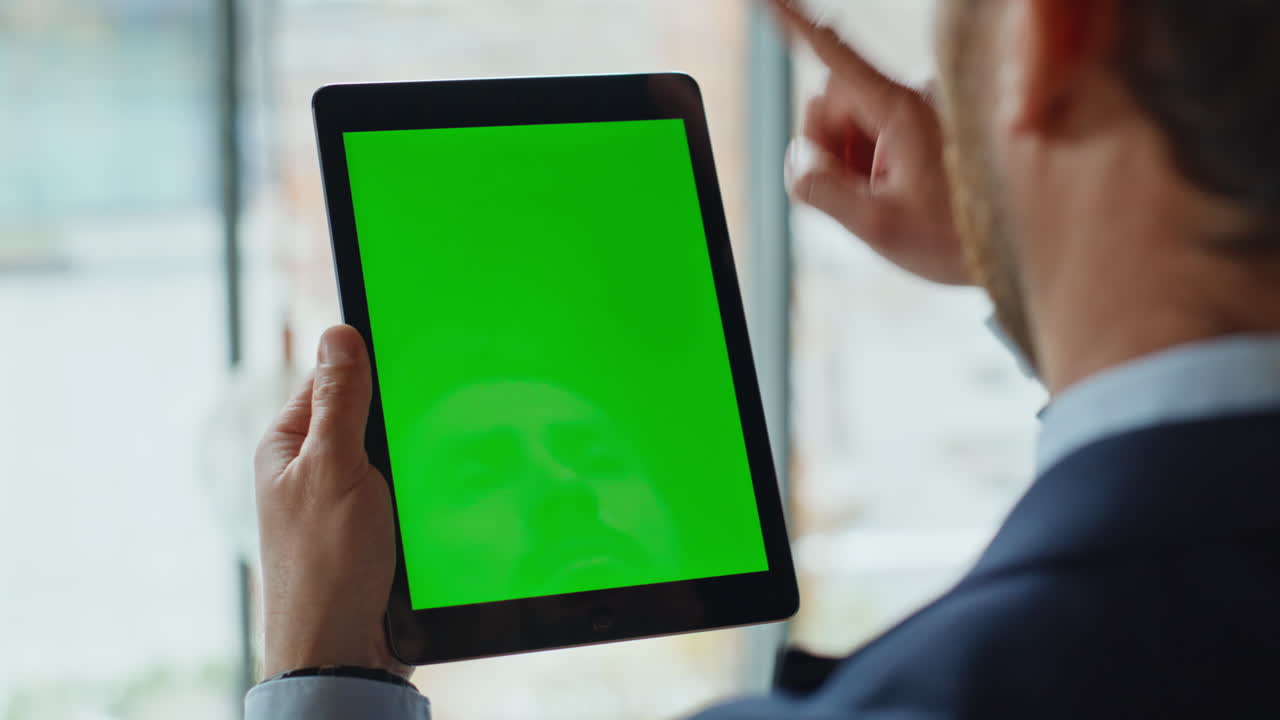 Office worker scrolling mockup tablet at workplace closeup. Unknown businessman