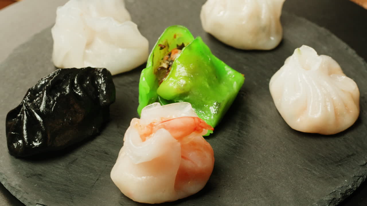 Assortment of Colorful Steamed Dim Sum Dumplings Rotating on a Plate