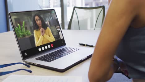 Animation-of-african-american-woman-having-video-call-on-laptop