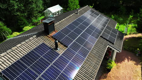 aerial view around reflecting pv modules on a self-sufficient, off-grid house