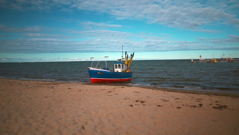 fishing boat slowly moving from the beach to the sea