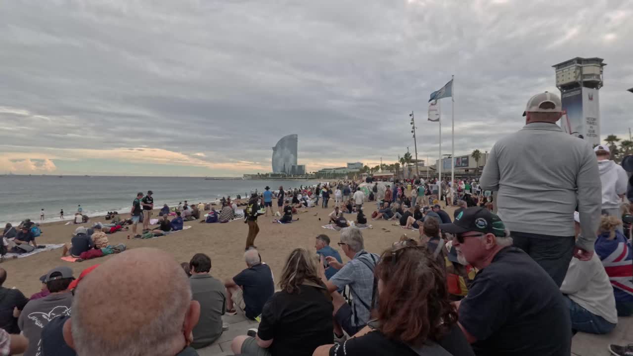 Crowds gather on Barceloneta Beach in Barcelona, Spain