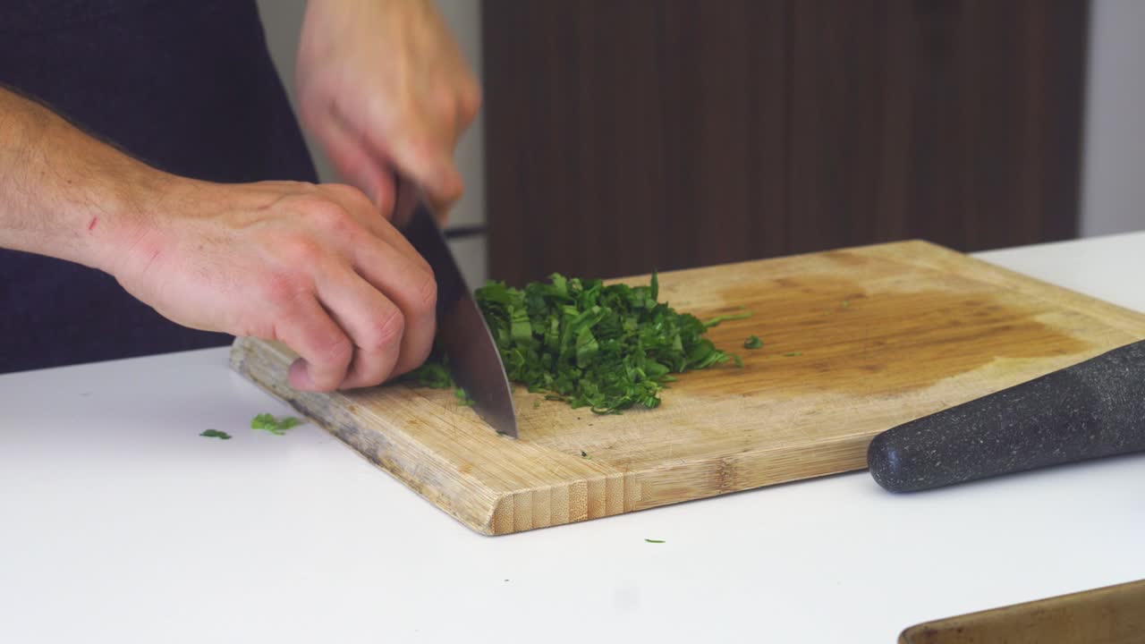 Finely chopping large bunch of mint herbs