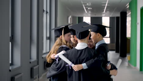 group of happy  preschool students in mortarboard and gown 9