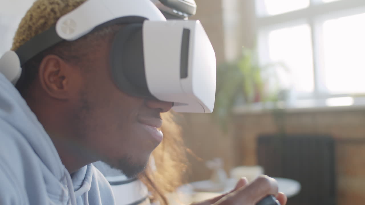 Smiling Black Man in VR Headset Playing Video Game with Wife