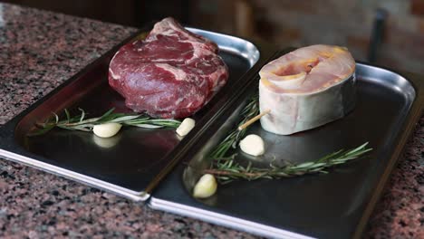 raw steak and fish ready for cooking