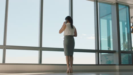 asian-business-woman-using-smartphone-corporate-sales-executive-chatting-to-client-financial-advisor-negotiating-deal-sharing-expert-advice-having-phone-call-in-office-looking-out-window