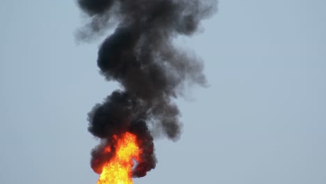 Thick-black-plume-of-smoke-and-roaring-fire-from-oil-refinery-flame-flare