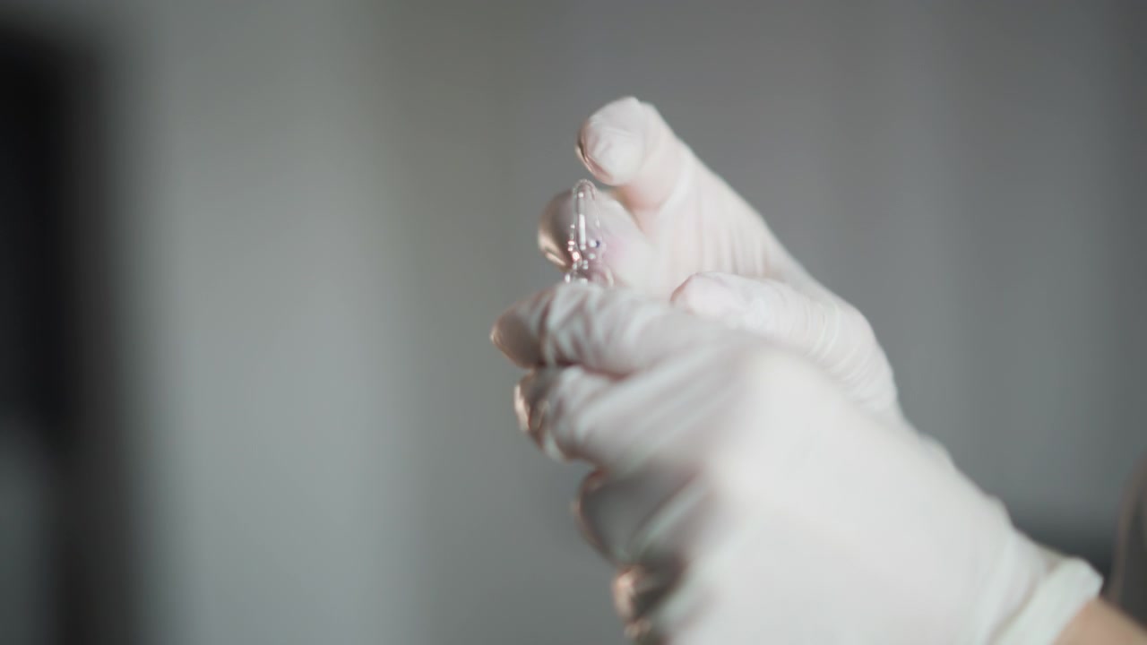 Careful injection in quiet setting. Medical professional handling vaccine with precision. Skilled healthcare worker carefully prepares vaccine ampoule in tranquil clinic space for injection