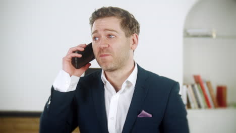 a happy young businessman is chatting on the phone