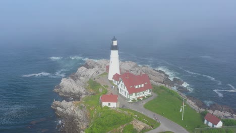 drone rising above light house ocean landscape in maine